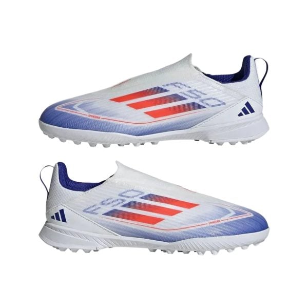 Pair of white turf soccer shoes with blue accents and red stripes, shown from side profiles against a plain background.