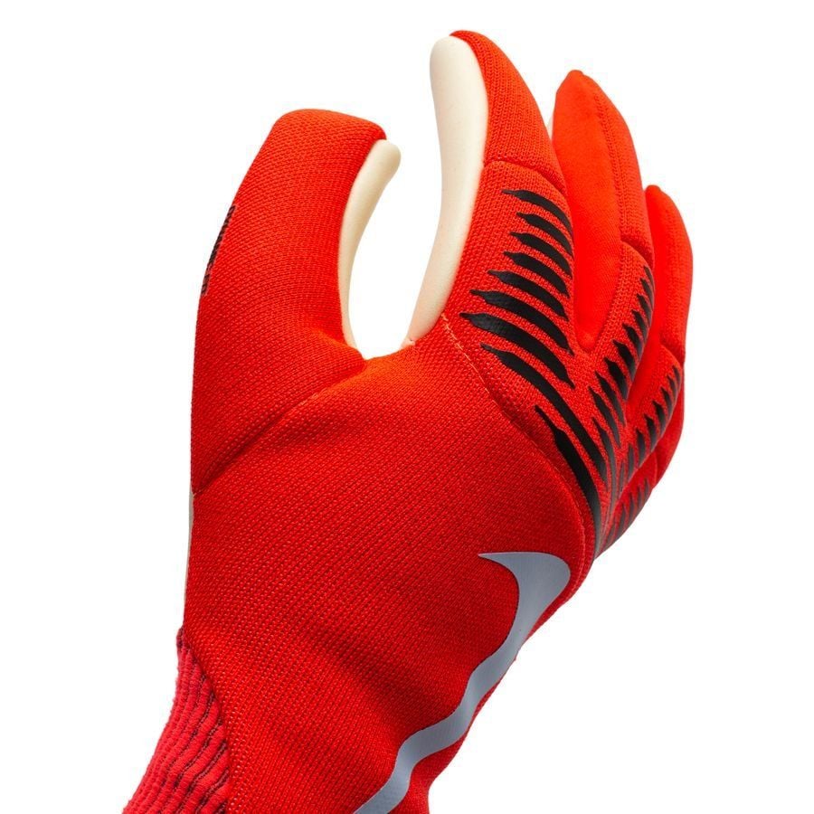 e794b6f71a2d487ff23cb6b503d31c76 | AE JERSEY Close-up of a red athletic glove with black grip stripes and a white Nike swoosh logo
