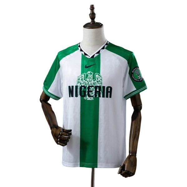 Nigeria national football team jersey on a mannequin, white with a green vertical stripe and 'NIGERIA' across the chest