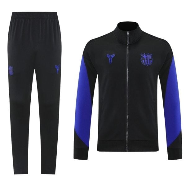 Black tracksuit: zip-front jacket with blue sleeve panels and FC Barcelona crest, paired with black jogger pants.
