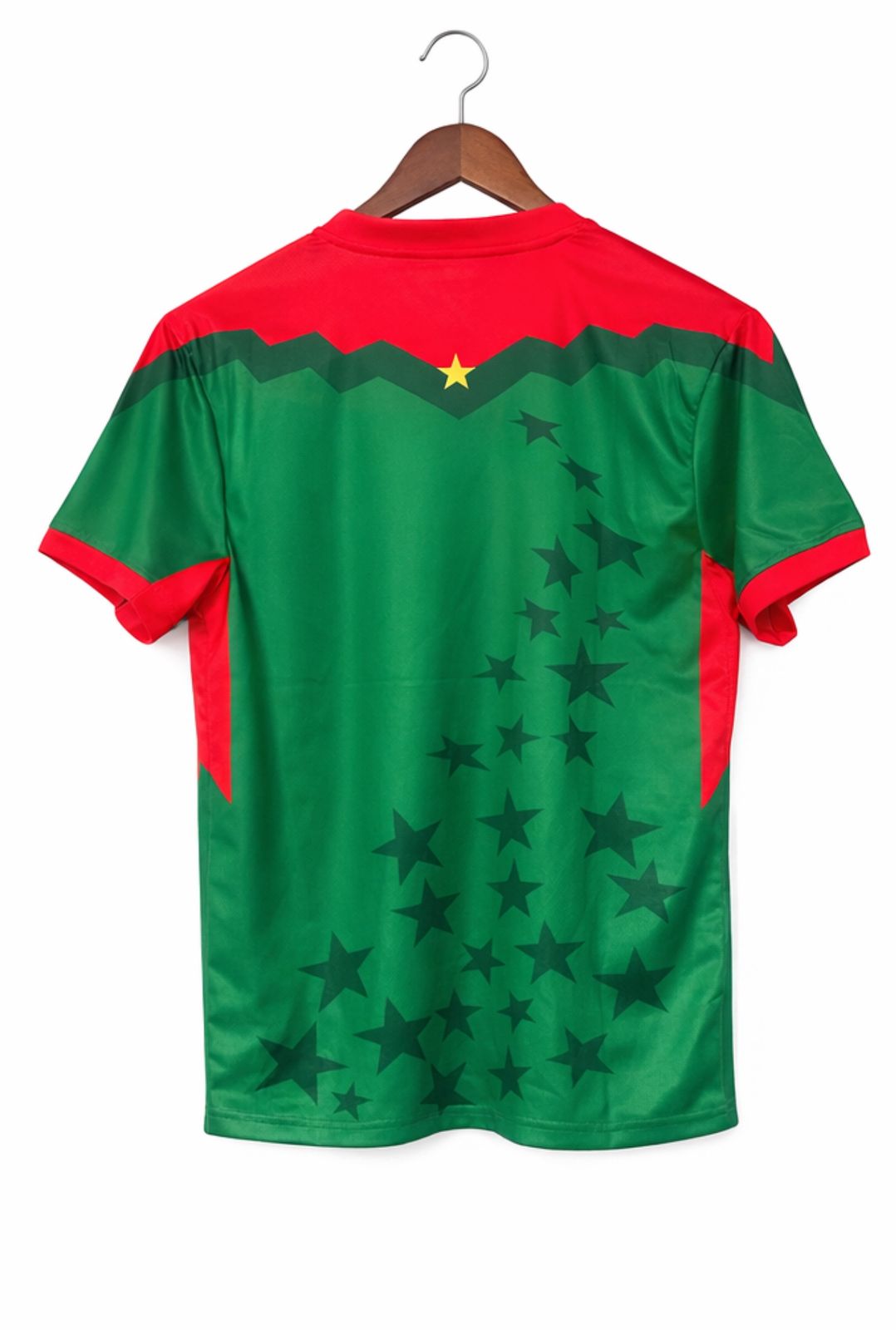 f33a77f2-5bd4-4137-bc63-46bac6efc379 | AE JERSEY Back view of a red-and-green sports jersey on a wooden hanger, with a diagonal star pattern across the green body and red shoulders.