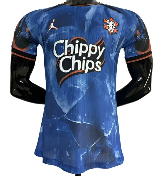 Blue athletic jersey featuring the 'Chippy Chips' sponsor logo and team crest on the chest, with a Puma logo and black sleeves with orange trim, displayed on a mannequin.