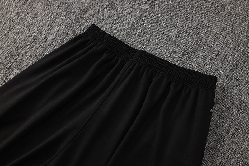f4e028f2 | AE JERSEY Black athletic shorts with an elastic waistband on a gray carpet surface, photographed from above.