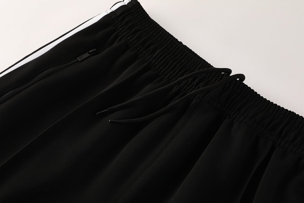f58fd2bf | AE JERSEY Black athletic pants with an elastic waistband and drawstrings, showing a small zip pocket on the front.