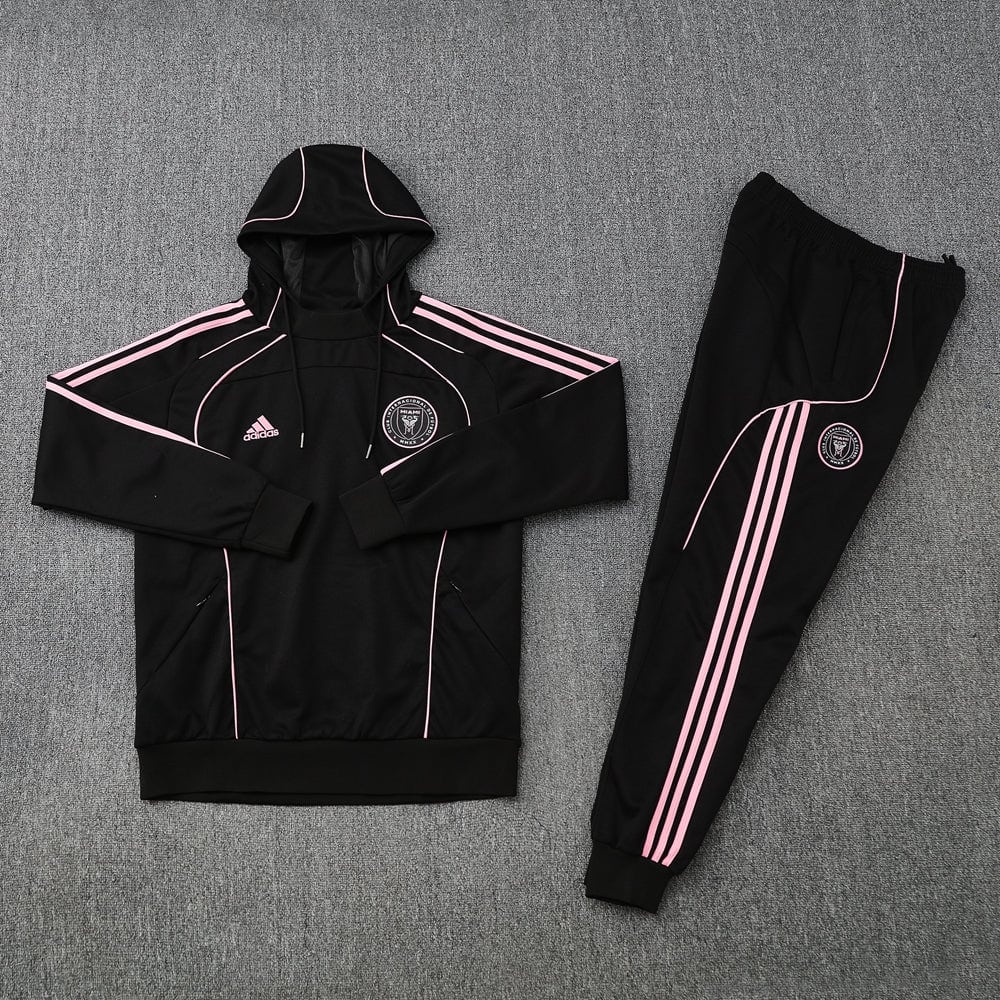 fd0ef2b2 | AE JERSEY Black Adidas tracksuit with pink piping, hoodie and jogger pants laid flat, pink stripes along sleeves and legs, circular logo on chest and thigh area