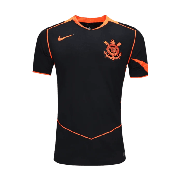 Front view of a black soccer jersey with orange piping and a crest on the left chest.