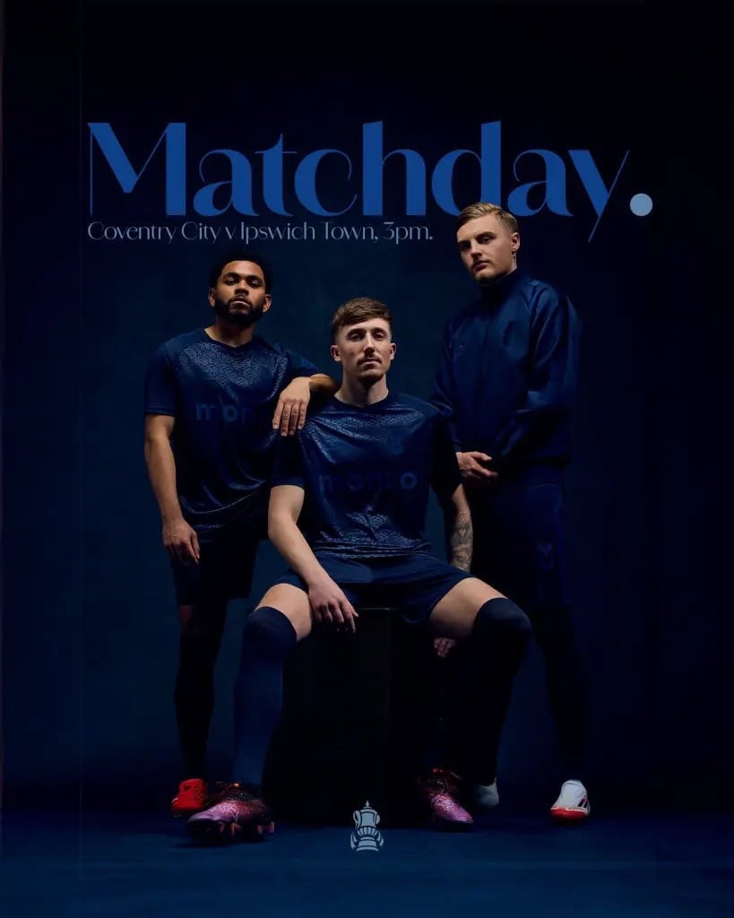 img_8390-1-819x1024-1 | AE JERSEY Promo image for a football match showing three players in navy training kits beneath a large 'Matchday' banner, with match details in small text above.