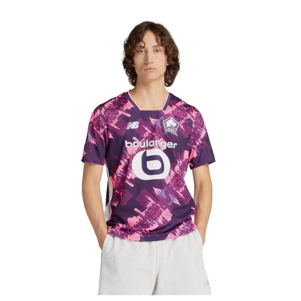Young man wearing a purple-pink LOSC soccer jersey with sponsor logos, standing against a white background.