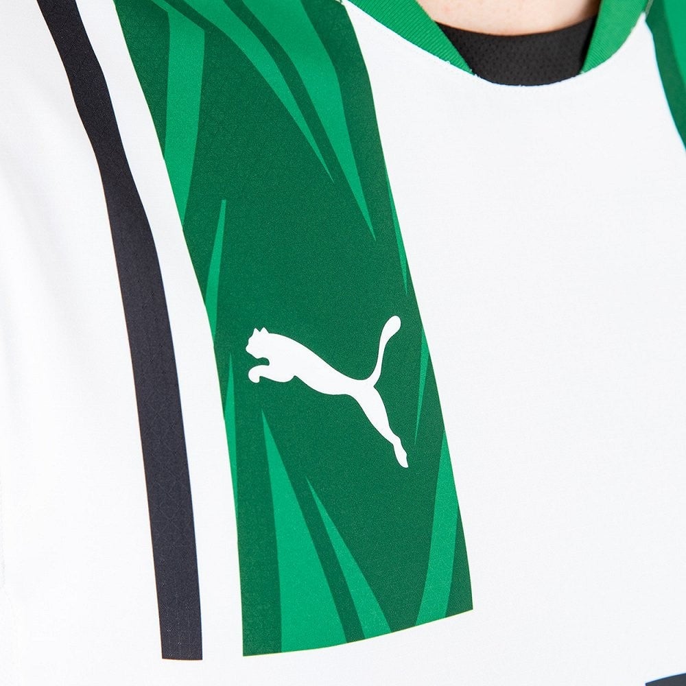 niKys8WlfVoutGw | AE JERSEY Close-up of a white Puma logo on a green panel of a sports jersey, with white and black trim visible.