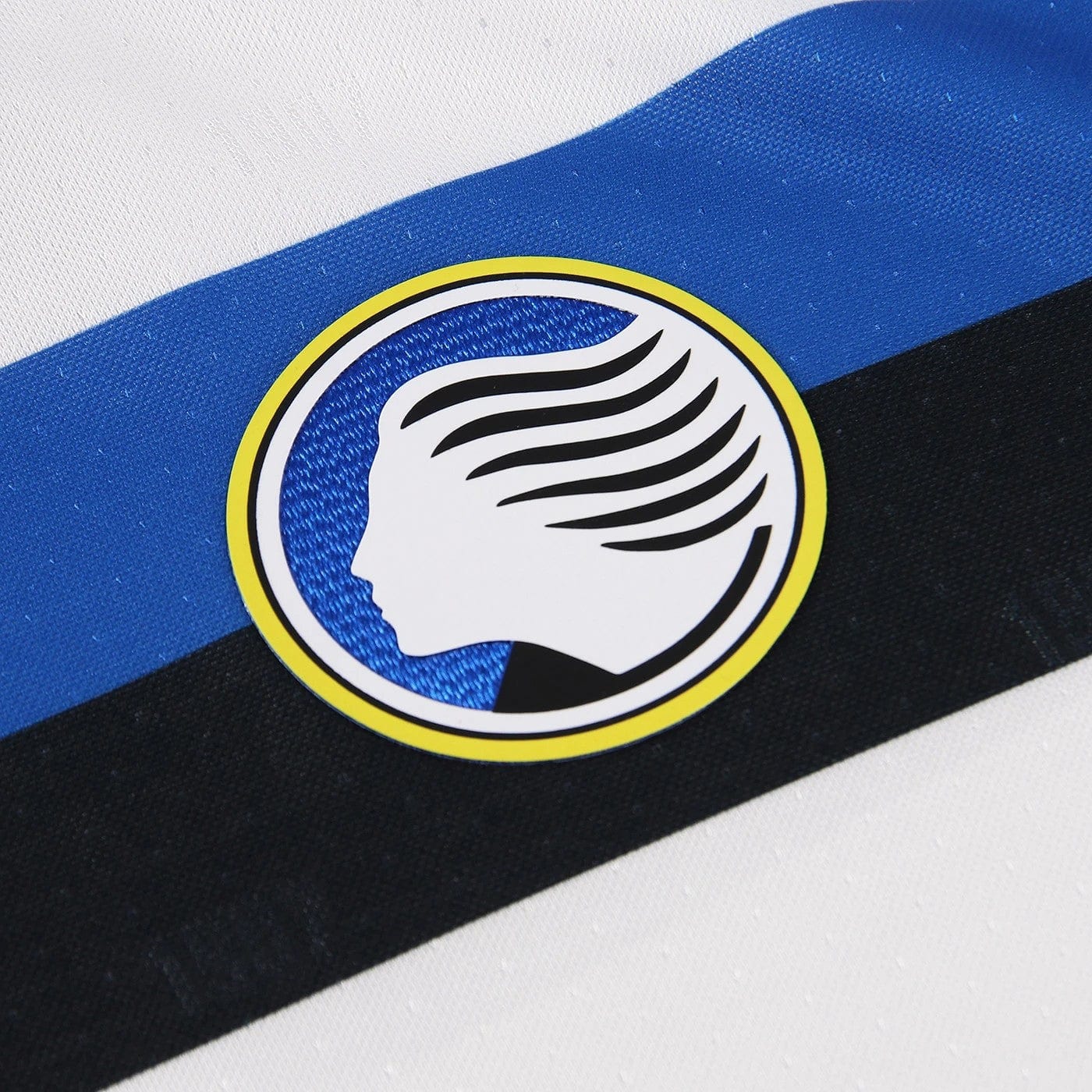 q5ZIca9jllcxOD5 | AE JERSEY Circular sticker featuring a white side-profile silhouette with stylized flowing hair inside a blue circle, outlined by a yellow ring.