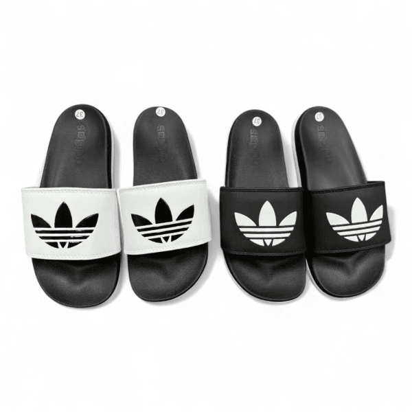 Four Adidas slide sandals arranged in a row: two white-strapped sandals on the left and two black-strapped sandals on the right, all with a prominent trefoil logo on the strap.