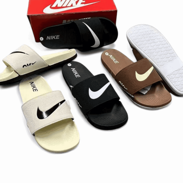Collection of Nike slide sandals in beige, black, brown, and white with a red Nike box in the background.