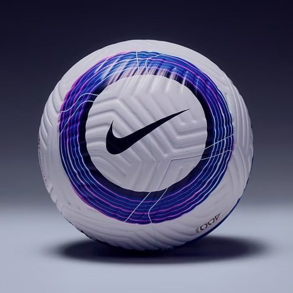 White Nike soccer ball with a purple-blue circular swirl pattern, resting on a dark gradient background.