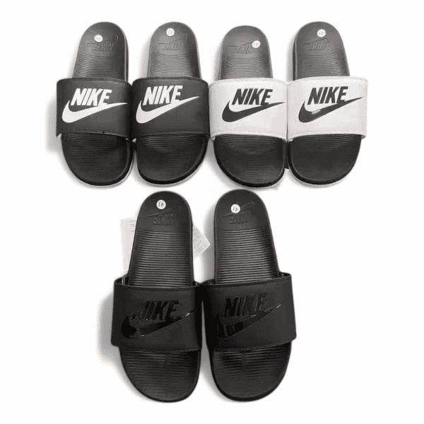 Display of four Nike slide sandals in black, white, and gray arranged in a row, showing Nike swoosh logos on the straps