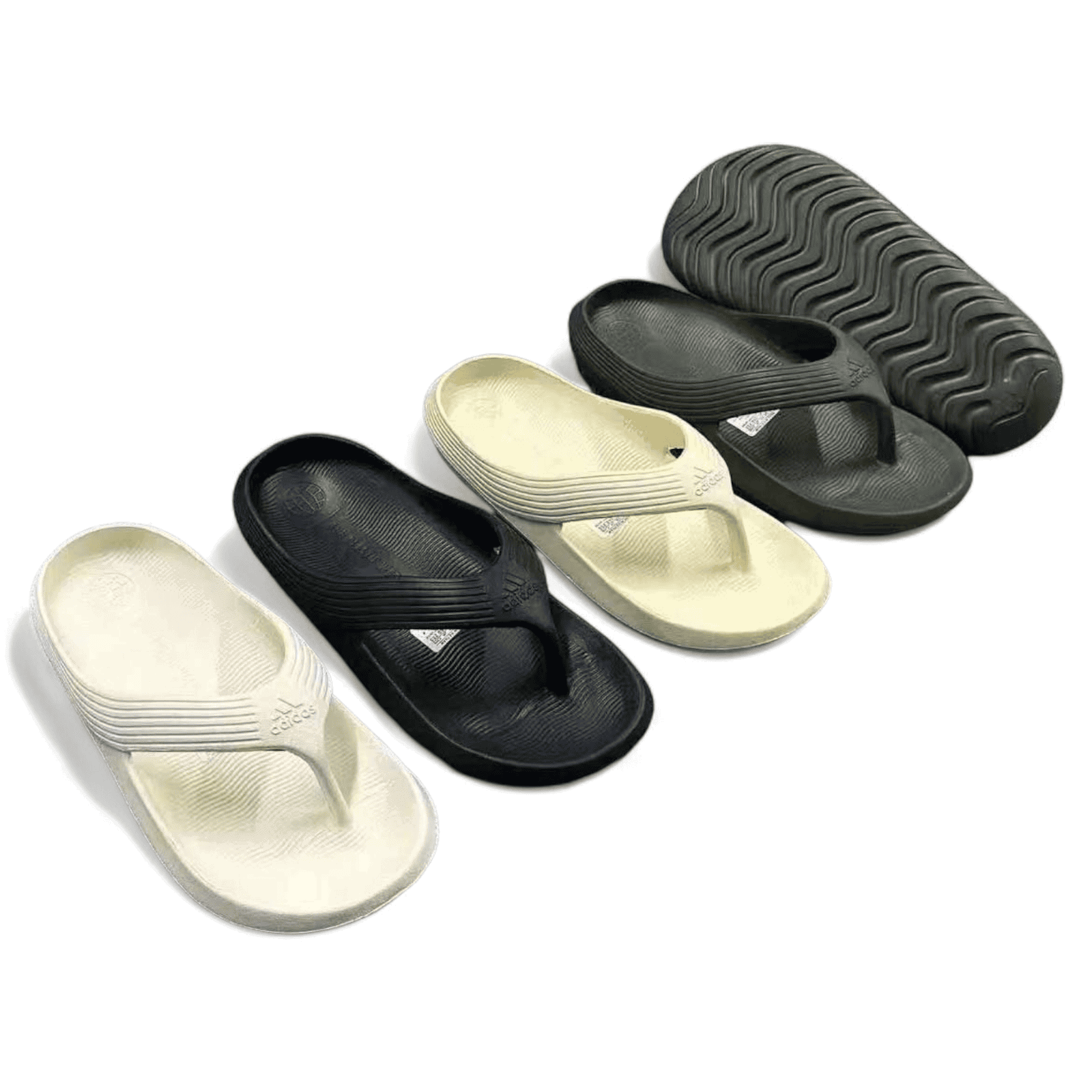 rn-image_picker_lib_temp_8e6ac3a1-b723-4dae-819d-762f2f326003 | AE JERSEY Assorted slide sandals in black and cream with textured soles