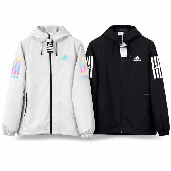 Pair of Adidas windbreaker jackets in white and black, each with a hood, zip front, and rainbow striped sleeves with logos.