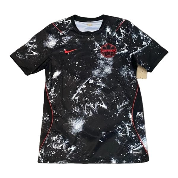 Black Canada national soccer team jersey with red Nike swoosh and white paint-splatter design on the front.