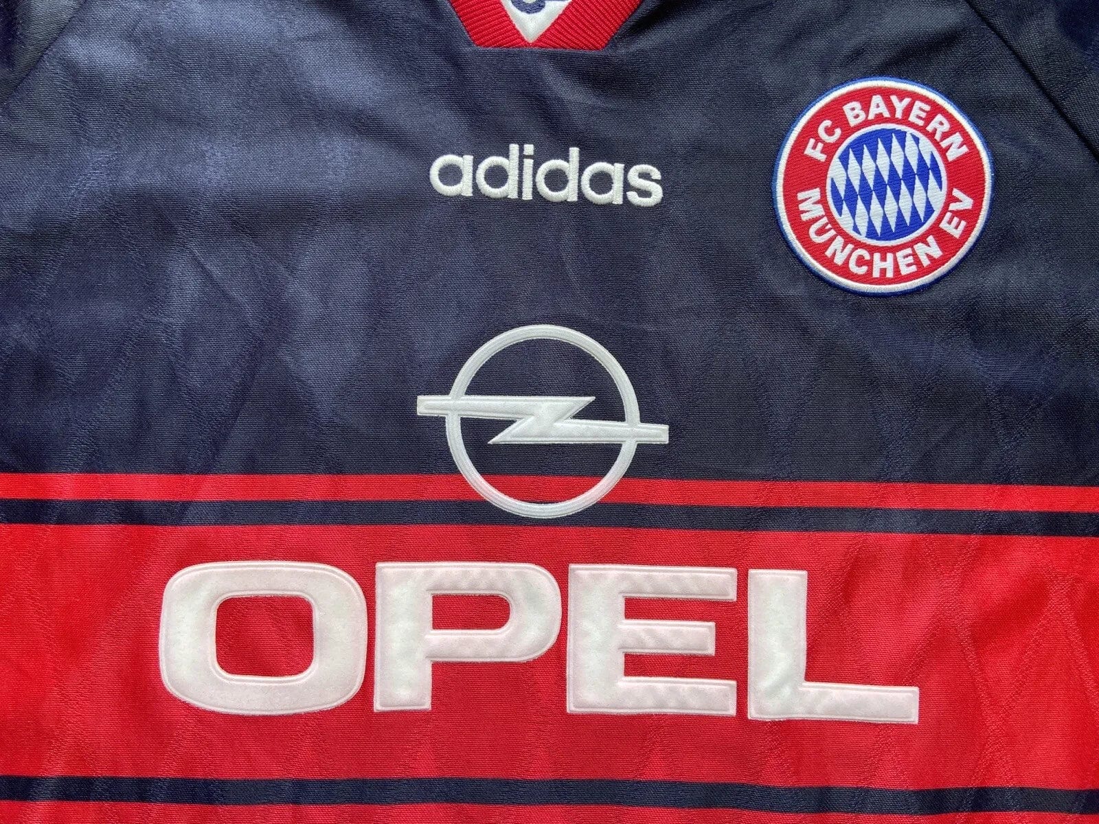 s-l1600_1_c133fa08-27a3-4054-950e-ae01ebdffd2b | AE JERSEY Dark blue FC Bayern jersey with Adidas logo, Opel emblem, and club badge visible on chest; red sponsor band at bottom reading OPEN partially.
