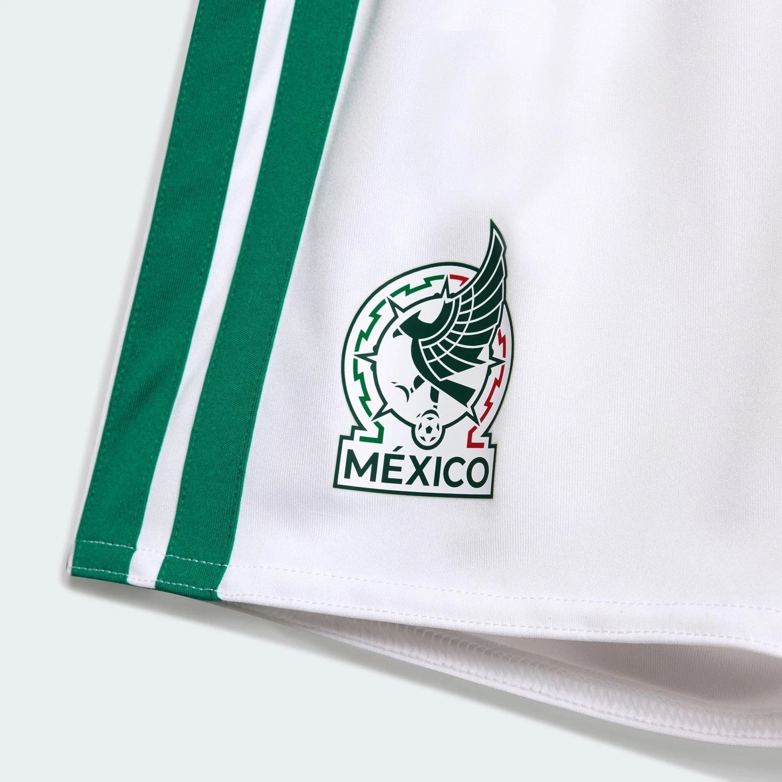 s-l1600_8_6082ecdb-93a7-4aab-a666-0f59cd7a8cc3 | AE JERSEY White sports jersey with green stripes and Mexico federation emblem on the chest, close-up detail.