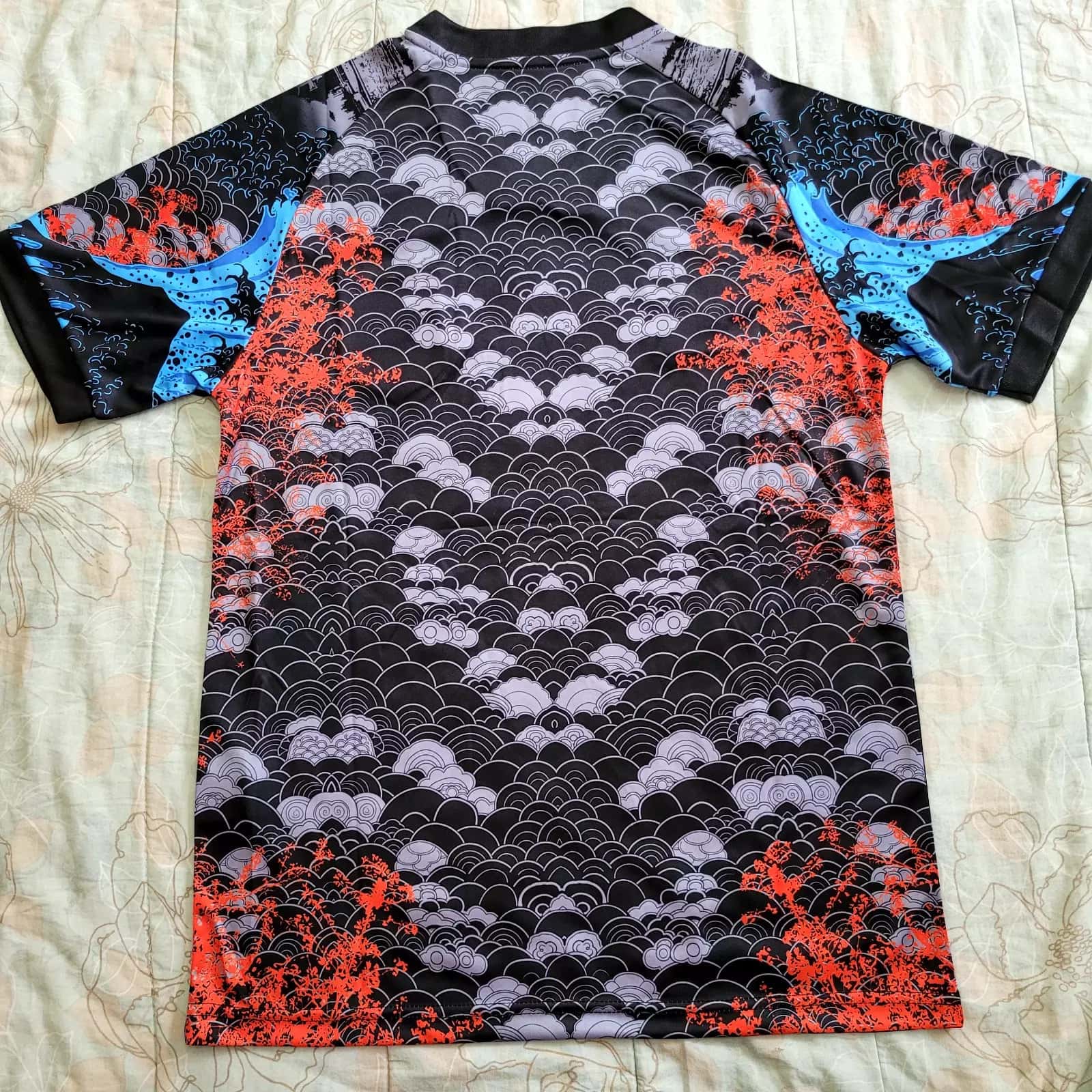 s-l1600_9_028f320b-f6c7-4d8e-a1f6-0ff7dd255026 | AE JERSEY Back view of a short-sleeve athletic jersey with black/gray wave pattern and red coral accents; blue panels on the sleeves.