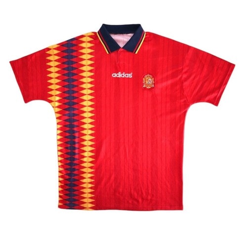 Red Adidas Spain soccer jersey featuring a yellow diamond pattern on the left panel, with a crest on the chest and a dark collar.