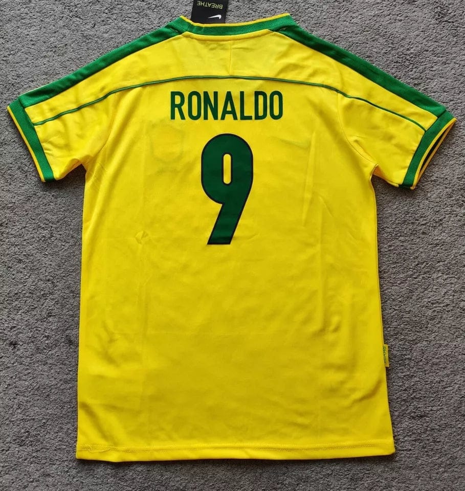 s-l960_10 | AE JERSEY Yellow Brazil national team soccer jersey laid flat, back shows name RONALDO and number 9 in green.